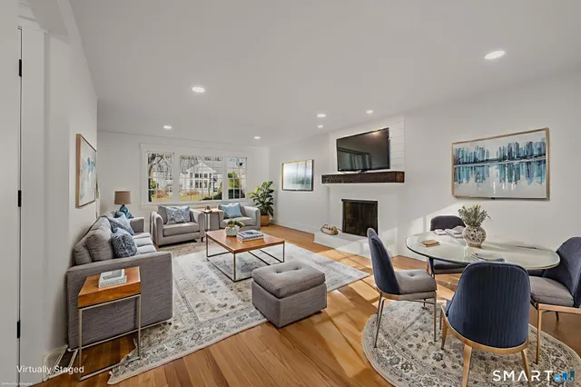 a living room with furniture fireplace and rug