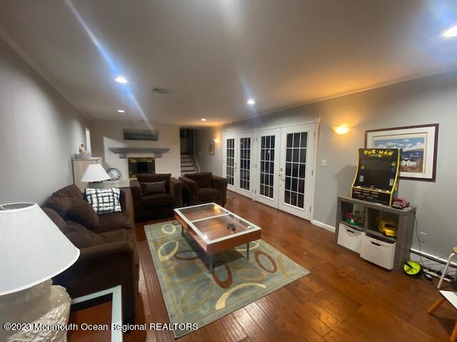 293 Lawrence Avenue Oakhurst, NJ 07755 - Photo 12 of 18 a living room with furniture a flat screen tv and a table