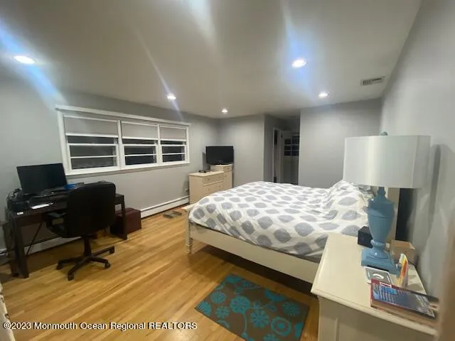 a bedroom with a large bed and a window