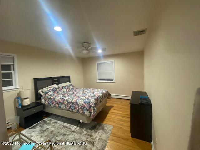 293 Lawrence Avenue Oakhurst, NJ 07755 - Photo 14 of 18 a bedroom with a bed and a night stand