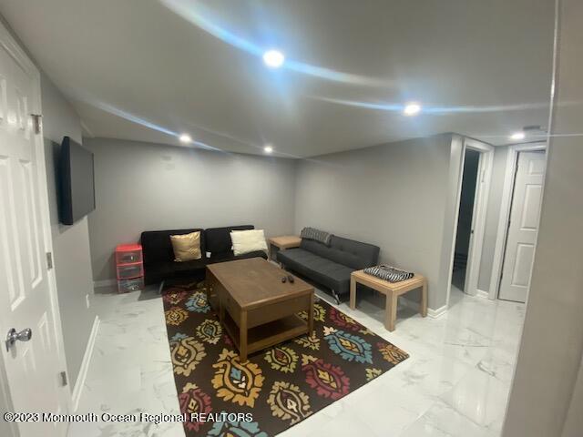 293 Lawrence Avenue Oakhurst, NJ 07755 - Photo 15 of 18 a living room with furniture and a flat screen tv