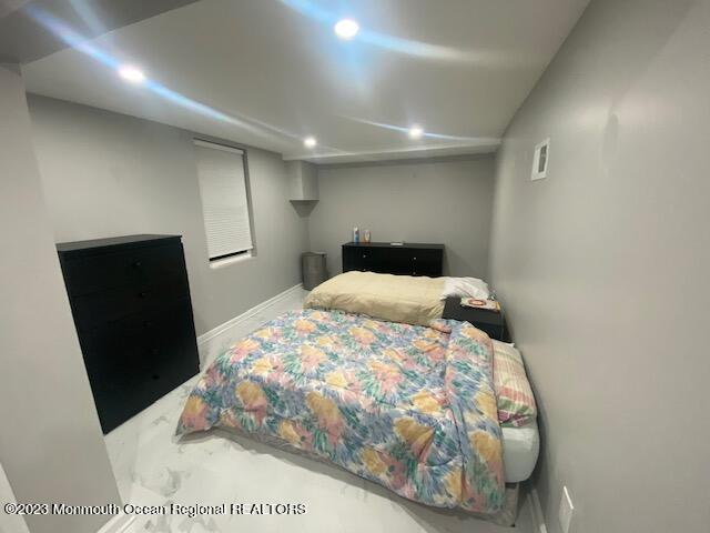 293 Lawrence Avenue Oakhurst, NJ 07755 - Photo 17 of 18 a bedroom with a bed and a mirror