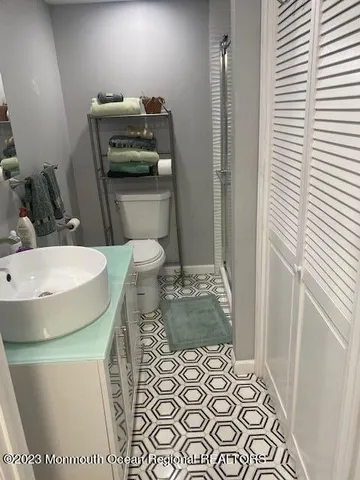 a bathroom with a sink toilet and shower