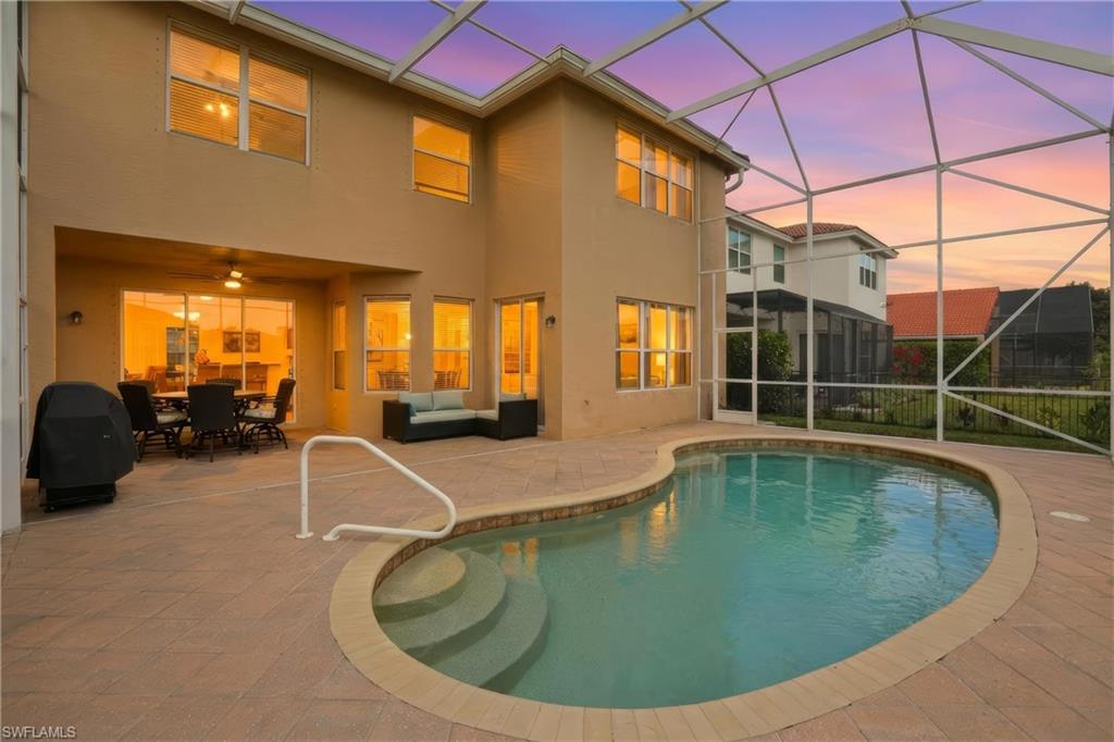 Outdoor pool featuring a lanai, a sunroom, a patio area, and outdoor lounge area