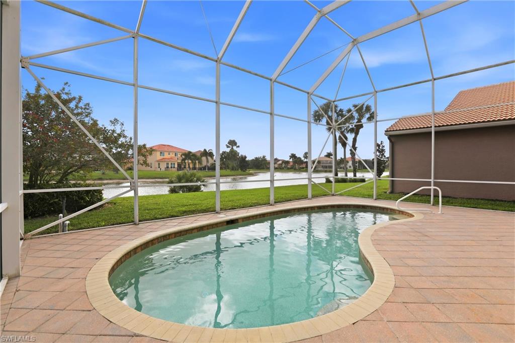 2150 Khasia Point Naples, FL 34119 - Photo 22 of 39 Swimming pool with a sunroom, glass enclosure, a water view, and a yard