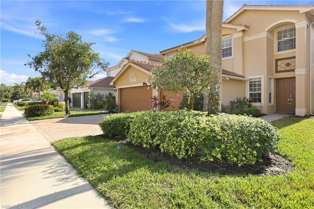 2150 Khasia Point Naples, FL 34119 - Photo 5 of 39 Mediterranean / spanish house featuring decorative driveway, stucco siding, a tiled roof, and a garage