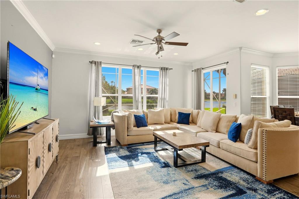 2150 Khasia Point Naples, FL 34119 - Photo 6 of 39 Living area featuring wood finished floors, ornamental molding, a ceiling fan, and recessed lighting