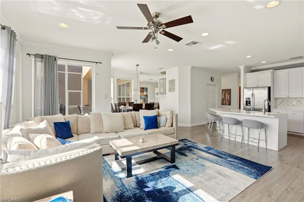 2150 Khasia Point Naples, FL 34119 - Photo 7 of 39 Living room featuring ornamental molding, recessed lighting, light wood-style floors, and a ceiling fan