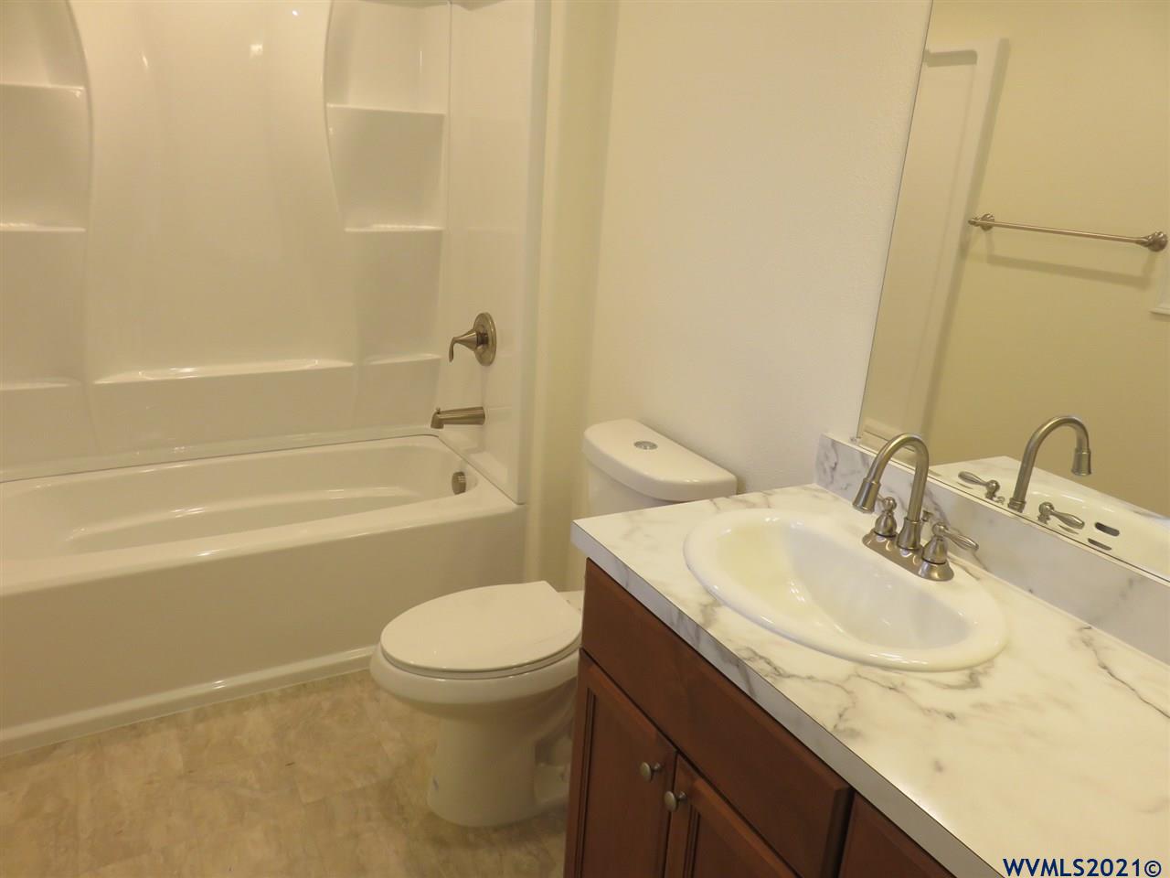 18990 Falls City Road Dallas, OR 97338 - Photo 36 of 42 a bathroom with a sink a toilet and shower