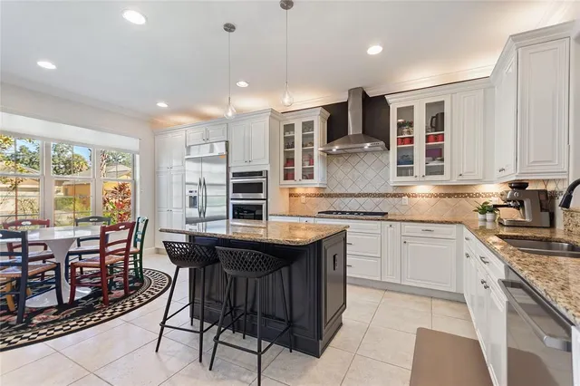 a bathroom with a granite countertop sink a toilet and shower