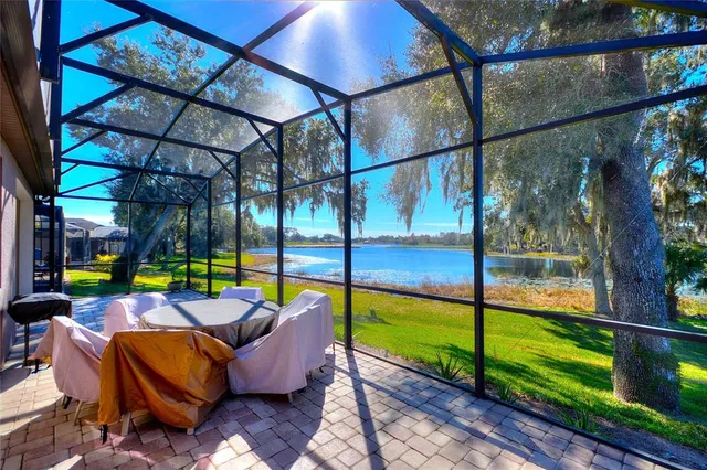 a front view of a house with a yard and potted plants