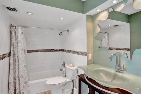 a bathroom with a sink toilet and shower