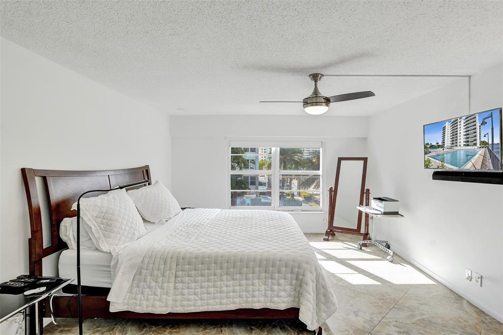 5100 Dupont Boulevard, Unit 3G Fort Lauderdale, FL 33308 - Photo 16 of 46 a bedroom with a bed a couch and a large window