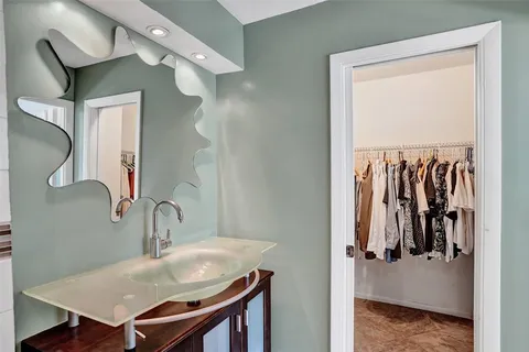 a en suite bathroom with a sink and mirror