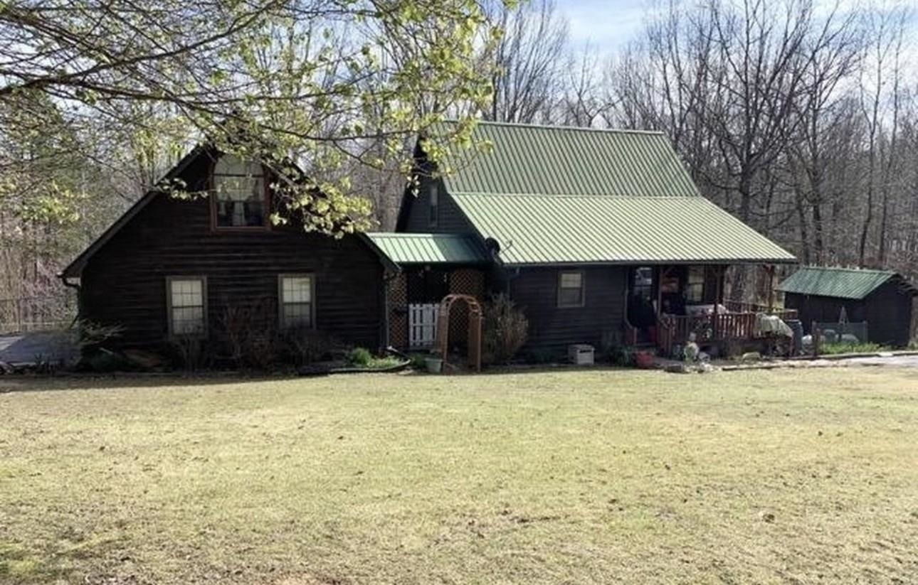 635 Pompeys Branch Road Savannah, TN 38372 - Photo 1 of 26 View of front of house featuring a front lawn, a metal roof, and covered porch