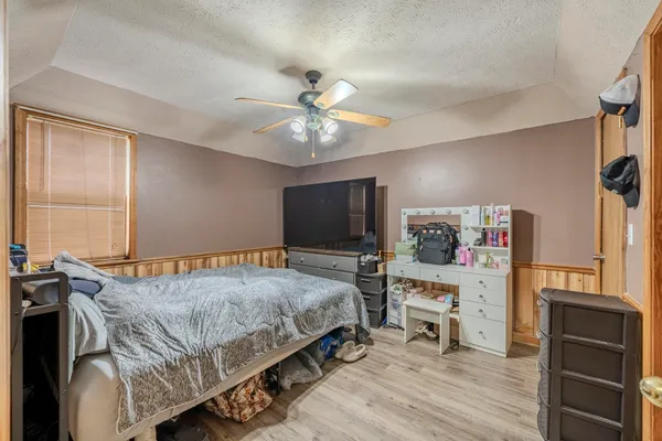 a bedroom with a bed and a flat screen tv