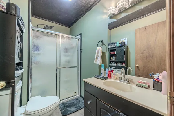a bathroom with a sink vanity mirror and toilet