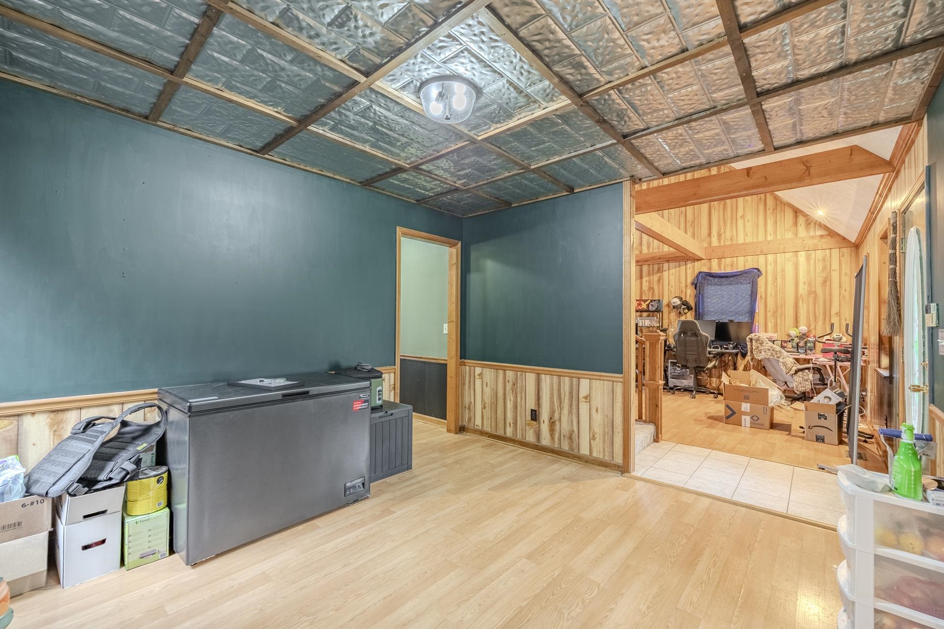 635 Pompeys Branch Road Savannah, TN 38372 - Photo 18 of 26 Unfurnished office featuring wood walls, light wood-type flooring, a wainscoted wall, and an ornate ceiling