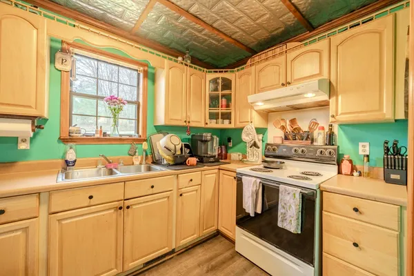 a kitchen with stainless steel appliances white cabinets and a window