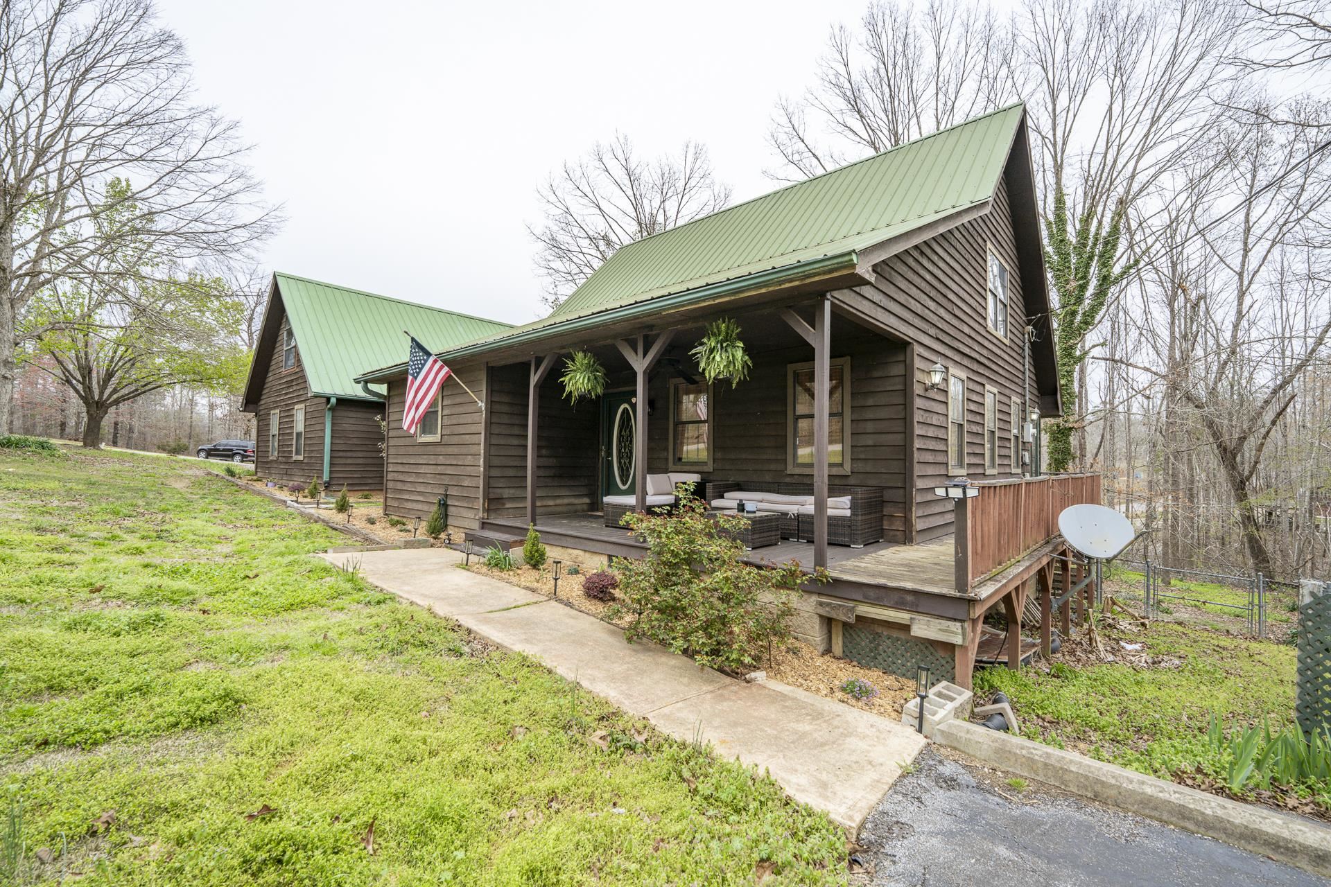 635 Pompeys Branch Road Savannah, TN 38372 - Photo 2 of 26 View of front facade featuring a metal roof, a front lawn, and covered porch