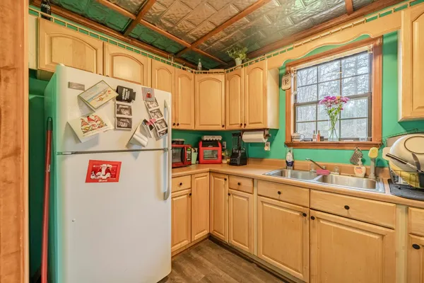 a kitchen with a refrigerator and a sink