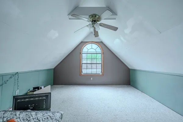a view of a livingroom with a ceiling fan and window