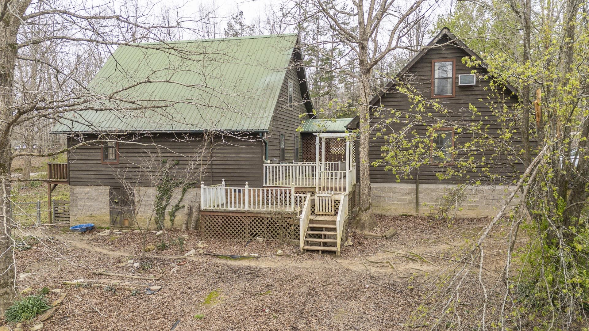 635 Pompeys Branch Road Savannah, TN 38372 - Photo 5 of 26 Rear view of property with a wooden deck and a metal roof