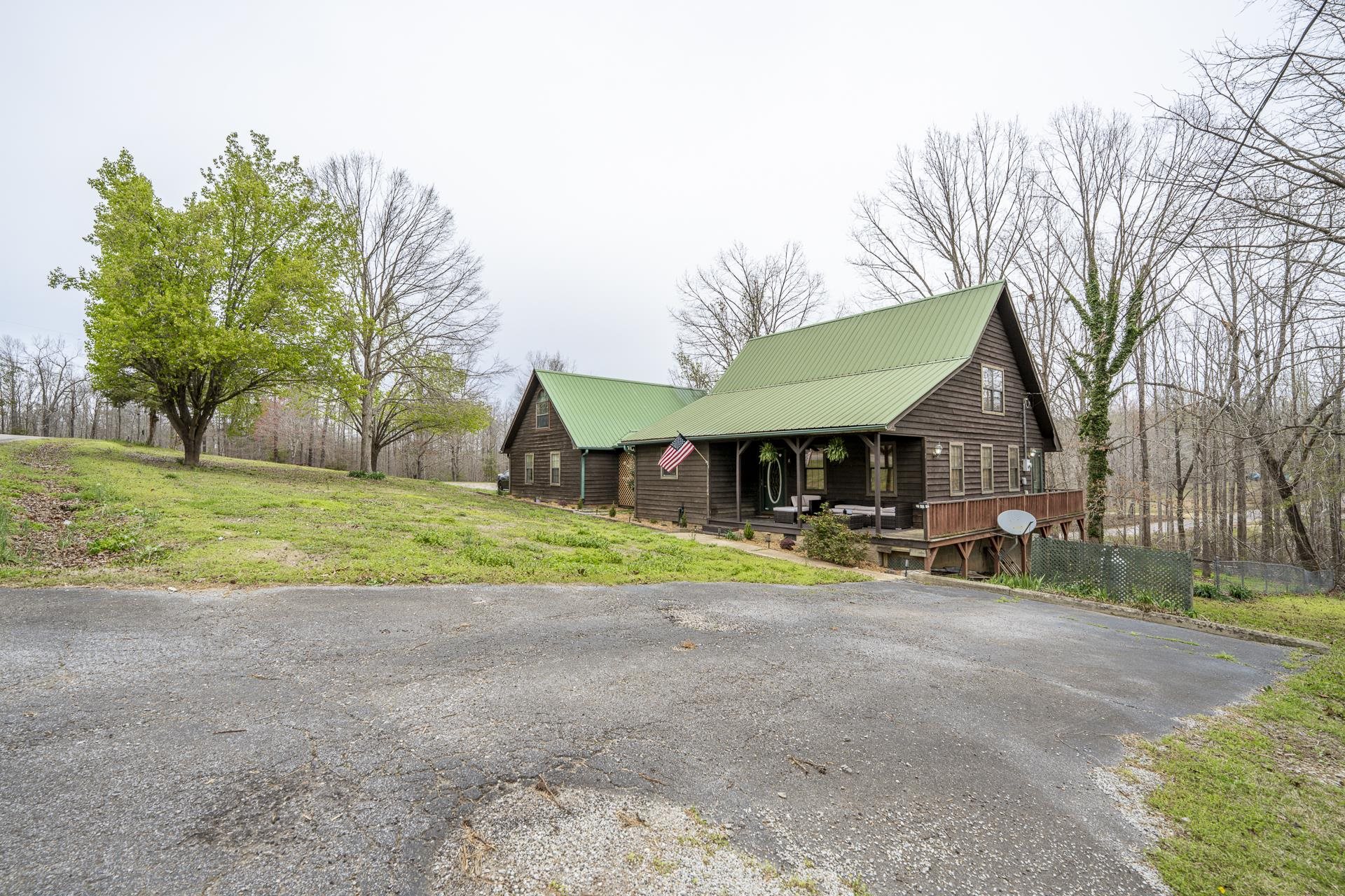 635 Pompeys Branch Road Savannah, TN 38372 - Photo 7 of 26 View of front of home with a metal roof and a front lawn
