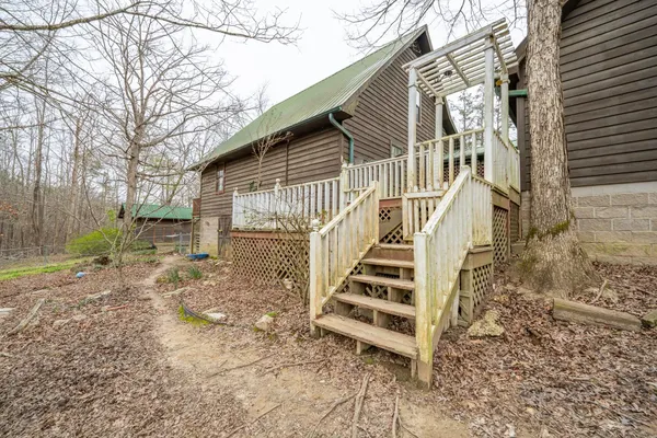 a view of a house with backyard and wooden fence