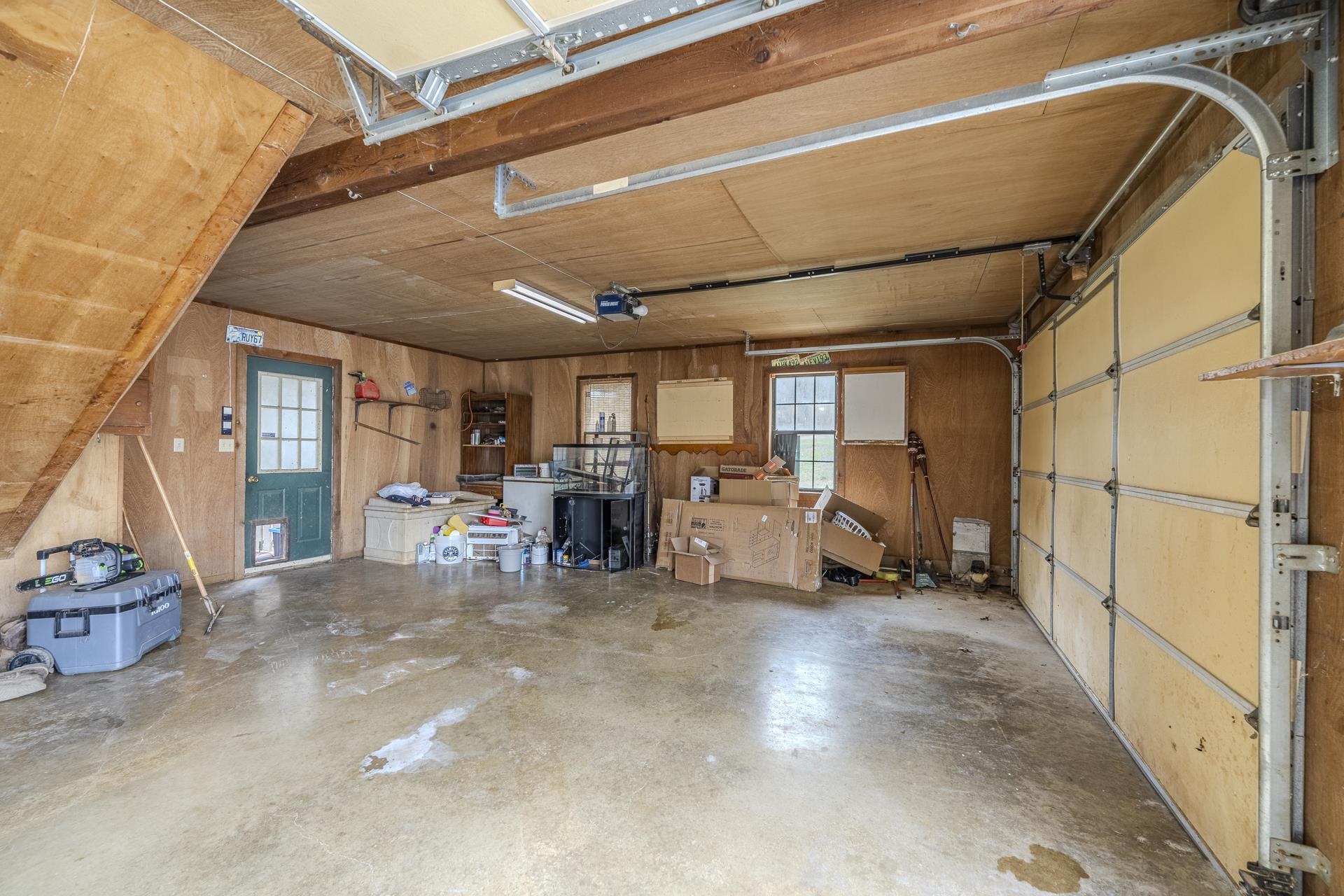 635 Pompeys Branch Road Savannah, TN 38372 - Photo 9 of 26 Garage with wooden walls and a garage door opener