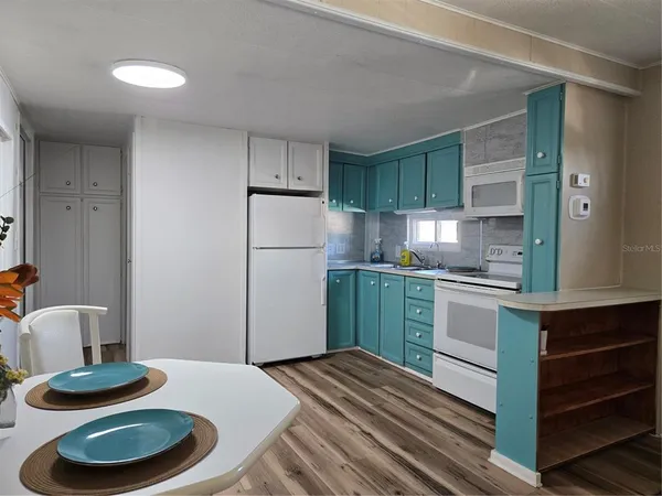 a kitchen with a refrigerator and a sink