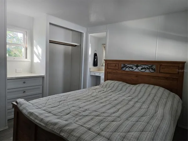 a bedroom with a bed and a dresser