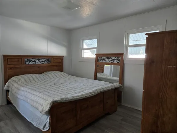 a bed sitting in a bedroom next to a window