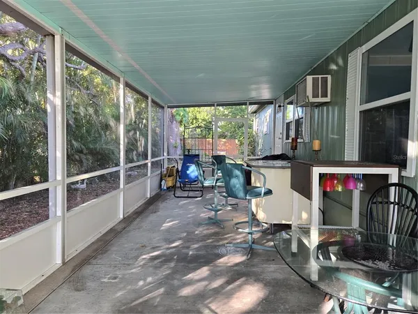a view of a porch with chairs and backyard