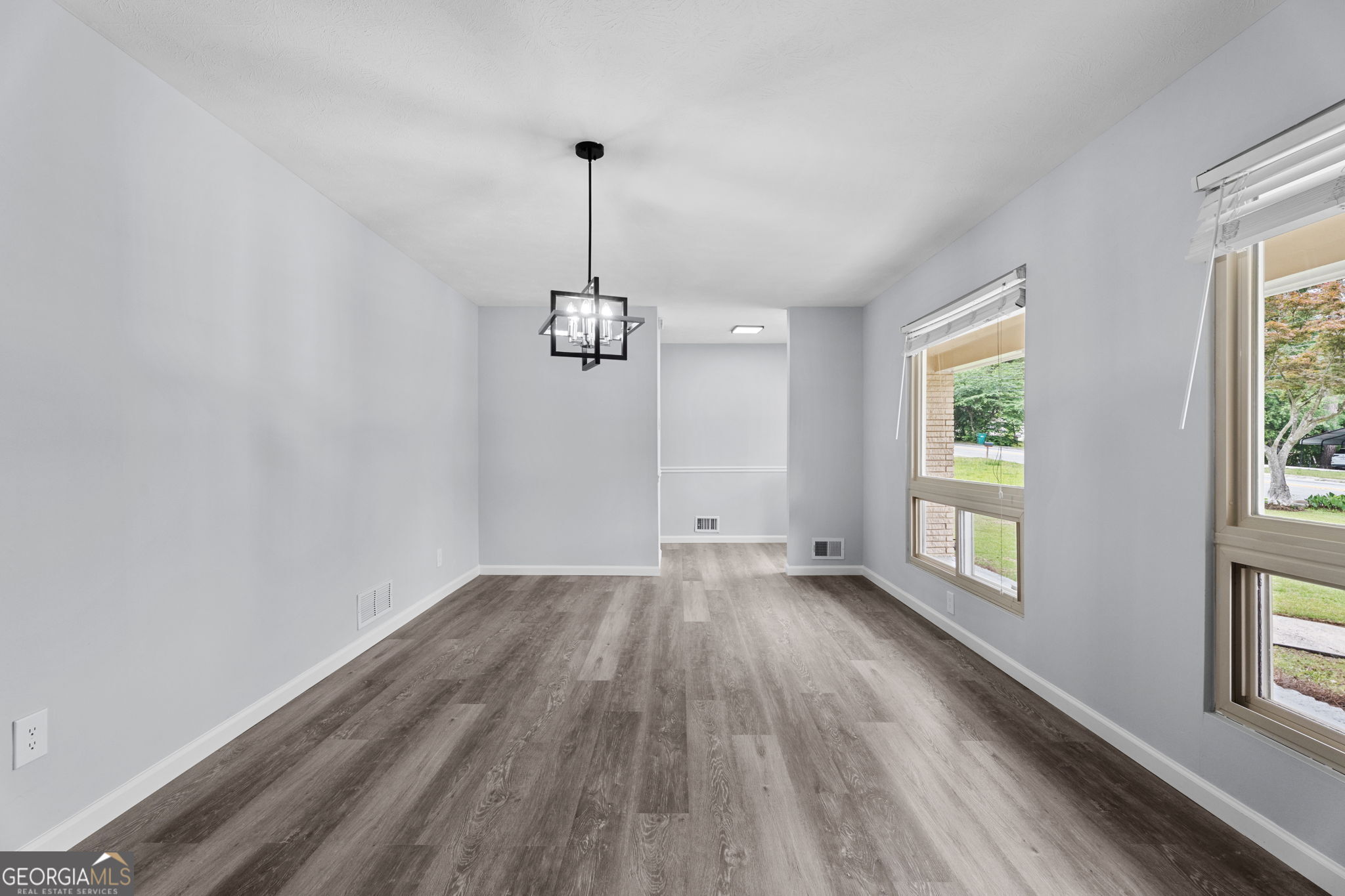 6463 Maddox Road Morrow, GA 30260 - Photo 16 of 46 a view of empty room with wooden floor and window