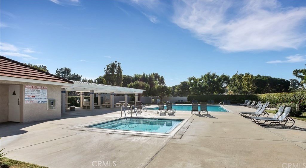 341 Stanford Court, Unit 26 Irvine, CA 92612 - Photo 23 of 24 a swimming pool with outdoor seating and yard in the back