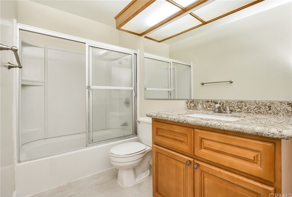 341 Stanford Court, Unit 26 Irvine, CA 92612 - Photo 3 of 24 a bathroom with a granite countertop sink toilet and shower