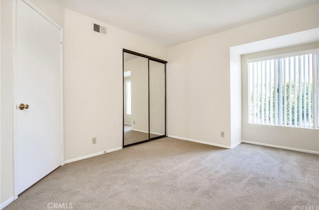 341 Stanford Court, Unit 26 Irvine, CA 92612 - Photo 8 of 24 an empty room with windows and closet