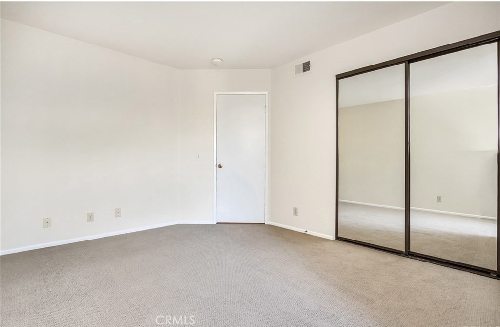 341 Stanford Court, Unit 26 Irvine, CA 92612 - Photo 10 of 24 an empty room with a sliding door