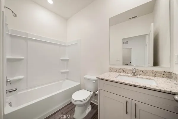 a bathroom with a granite countertop sink mirror and shower