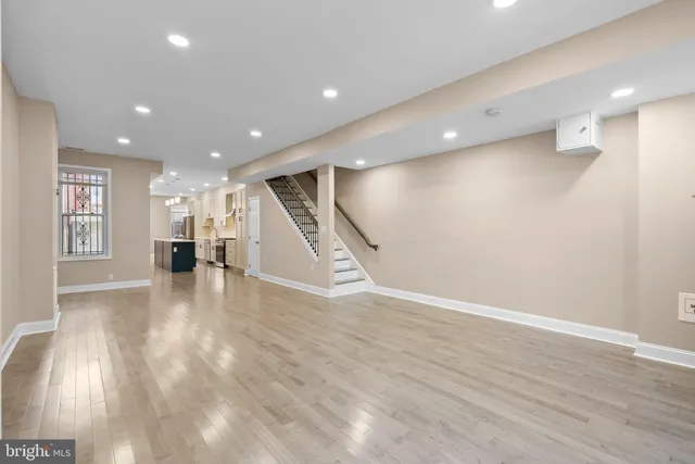 a kitchen with white cabinets sink and stove