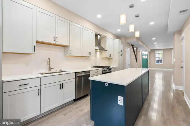 a kitchen with stainless steel appliances a refrigerator and cabinets