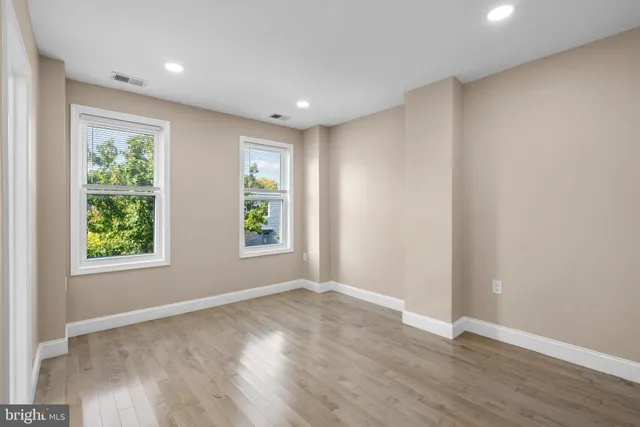 wooden floor in an empty room with a fireplace