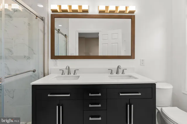a bathroom with a sink vanity and a mirror