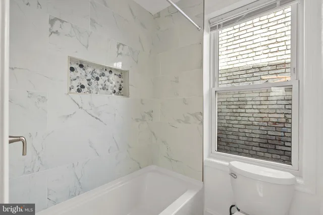 a view of a brick house with large windows