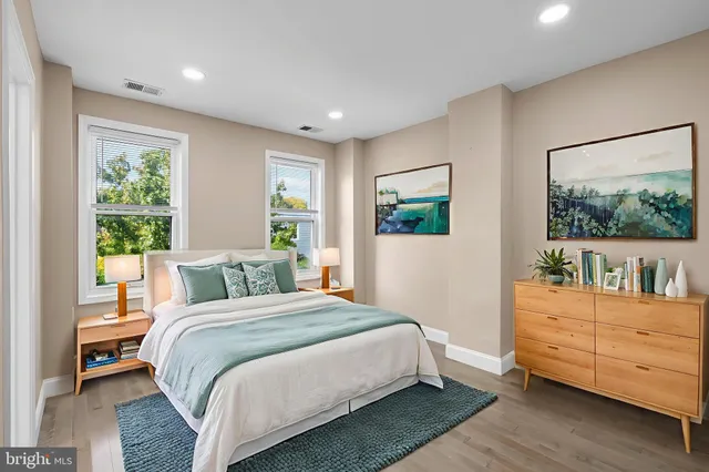 a bedroom with a bed and a dresser