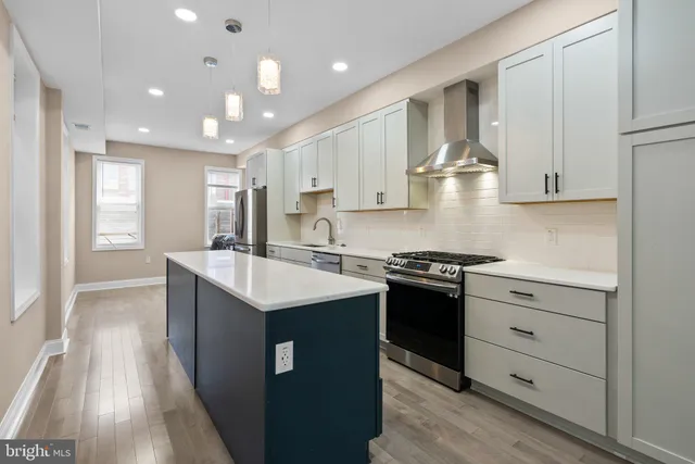 a kitchen with a sink stove and cabinets
