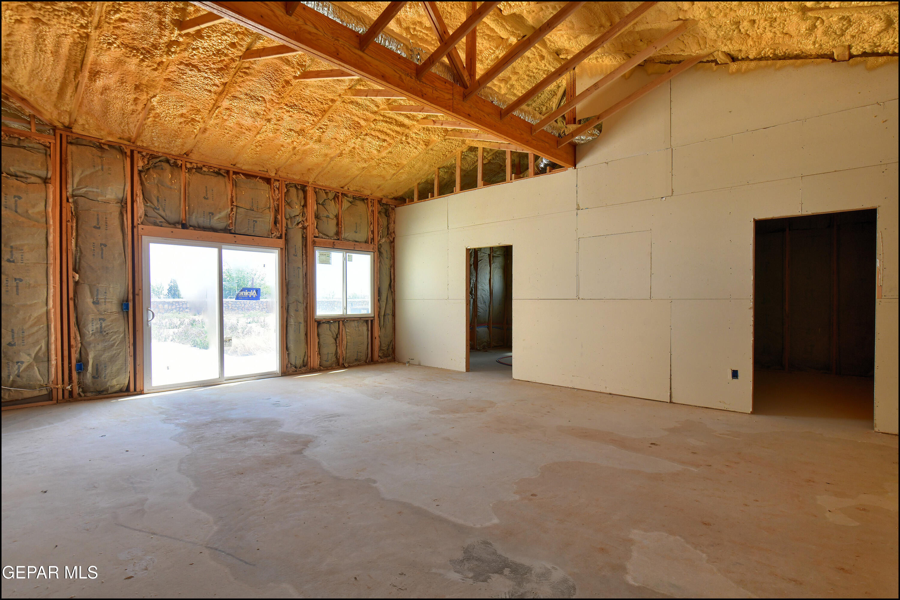 13360 Ayla Road El Paso, TX 79938 - Photo 27 of 48 a view of a big room with a windows and brick walls