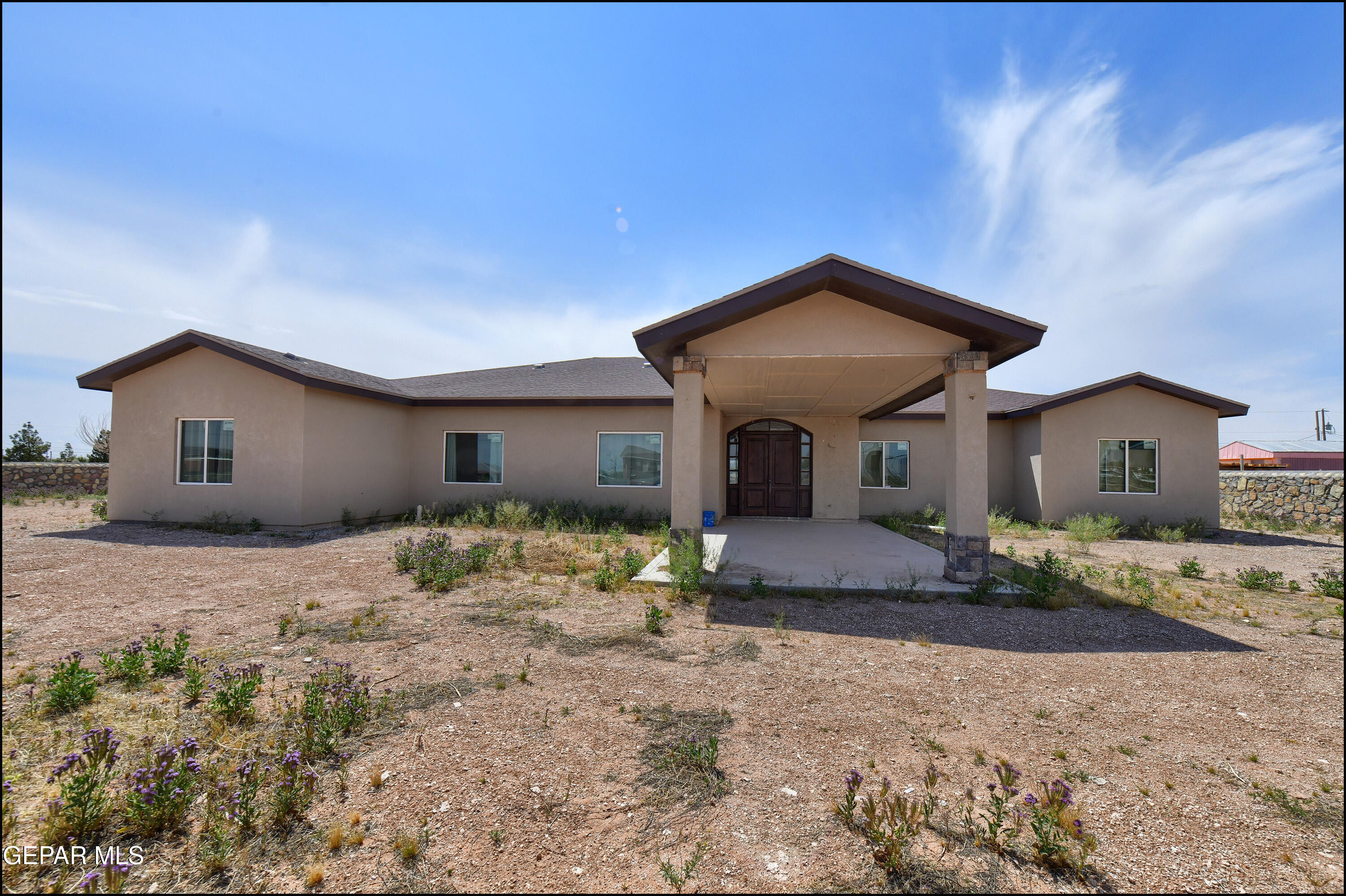 13360 Ayla Road El Paso, TX 79938 - Photo 3 of 48 a front view of a house with a yard and pathway