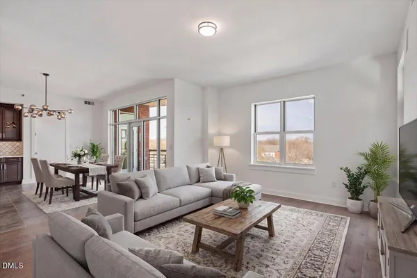a living room with furniture and wooden floor